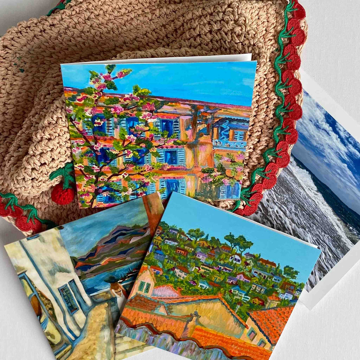 Colourful greeting cards with scenic designs on a textured surface