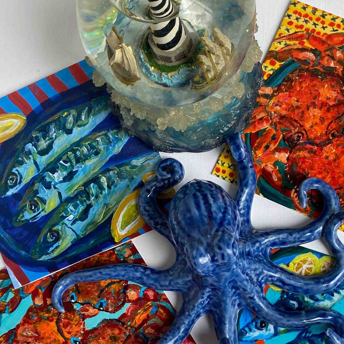 Decorative blue octopus with a colourful background featuring artistic depictions of fish and a crab.